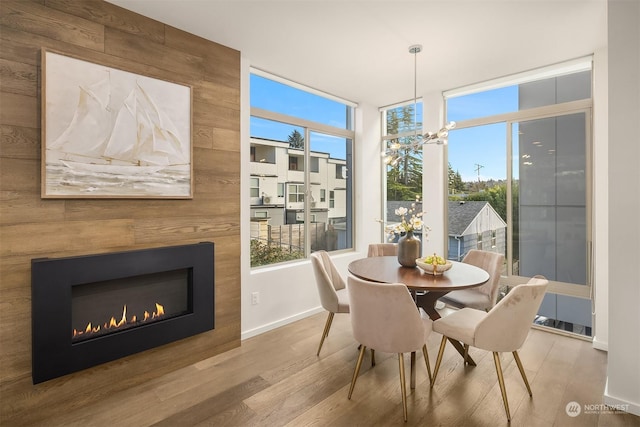 dining space featuring hardwood / wood-style floors, plenty of natural light, and a chandelier