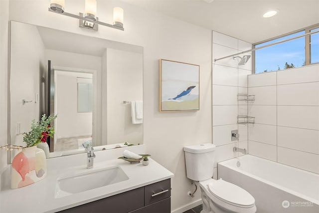 full bathroom with vanity, toilet, and tiled shower / bath combo