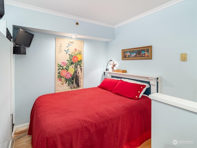 bedroom with crown molding and light hardwood / wood-style flooring