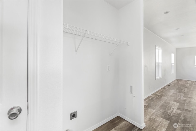 washroom with hardwood / wood-style flooring and hookup for an electric dryer