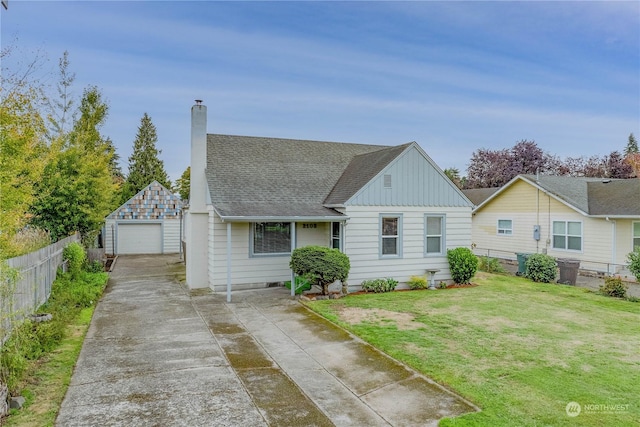 view of front of house with a garage, an outdoor structure, and a front lawn