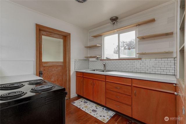 kitchen featuring sink, backsplash, dark hardwood / wood-style flooring, crown molding, and black electric range