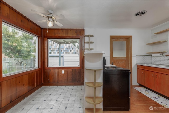 kitchen with sink, electric range, a wealth of natural light, and ceiling fan