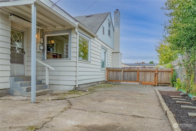 view of property exterior with a patio area