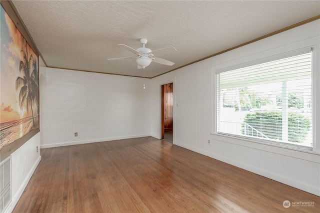 spare room featuring ceiling fan, dark hardwood / wood-style floors, crown molding, and a textured ceiling