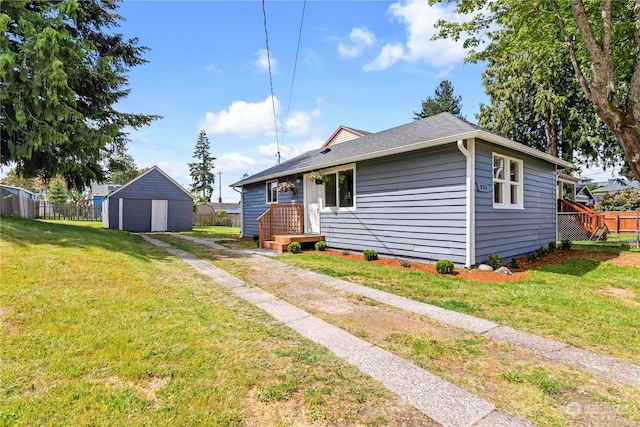 view of front of property featuring a storage shed and a front lawn