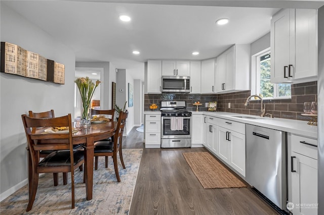 kitchen featuring sink, dark wood-type flooring, white cabinets, and appliances with stainless steel finishes