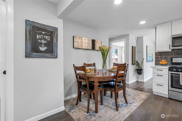 dining space with dark hardwood / wood-style floors