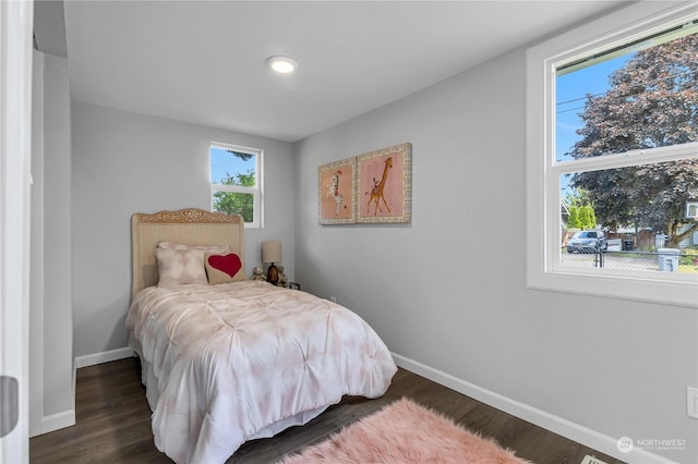 bedroom with dark hardwood / wood-style flooring