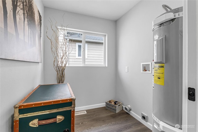 laundry area featuring dark wood-type flooring, hookup for a washing machine, electric water heater, and electric dryer hookup