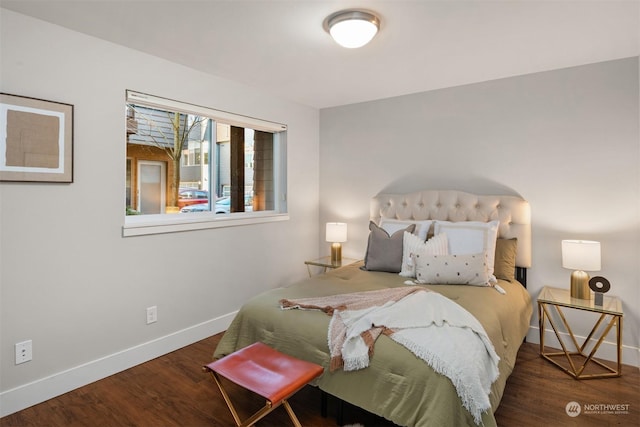 bedroom with dark hardwood / wood-style flooring