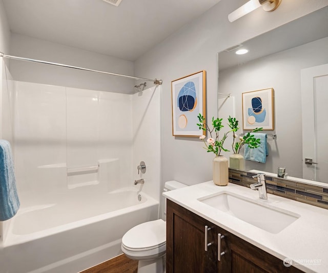 full bathroom featuring shower / bathing tub combination, vanity, and toilet