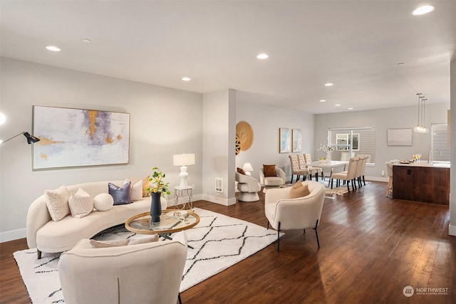 living room featuring dark hardwood / wood-style floors and sink