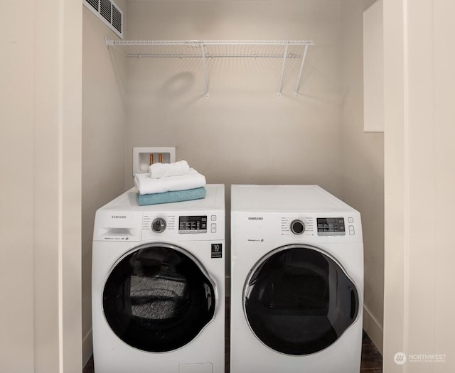 laundry room featuring separate washer and dryer