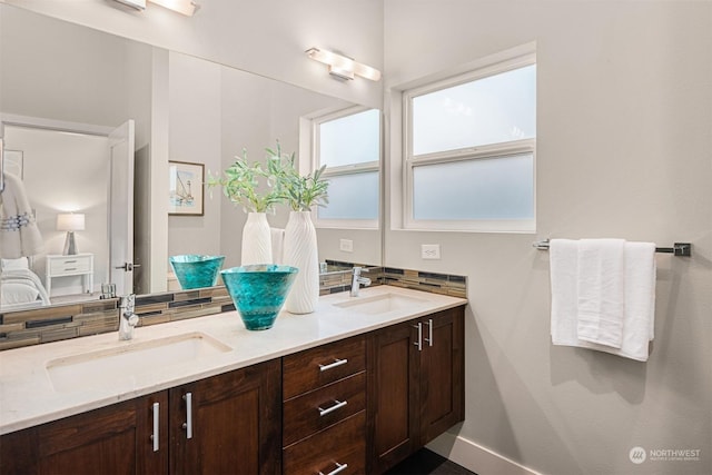 bathroom with vanity and decorative backsplash