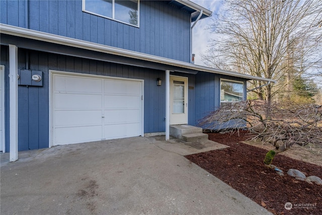 doorway to property with a garage