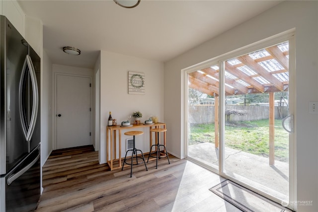 doorway to outside with wood-type flooring