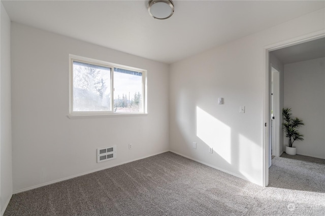 spare room featuring carpet flooring and heating unit