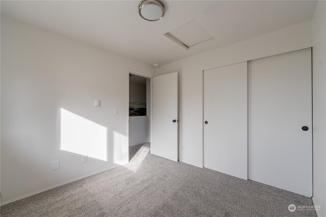 unfurnished bedroom with carpet floors and a closet