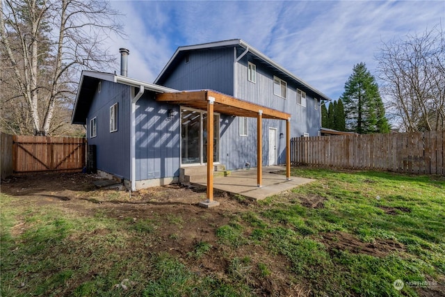 back of property with a patio and a yard