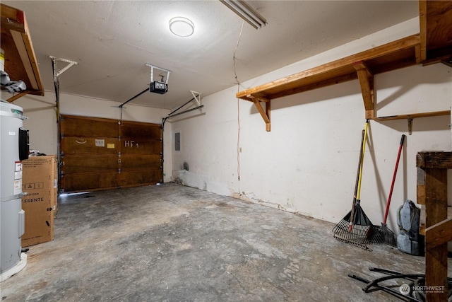 garage with a garage door opener and electric water heater