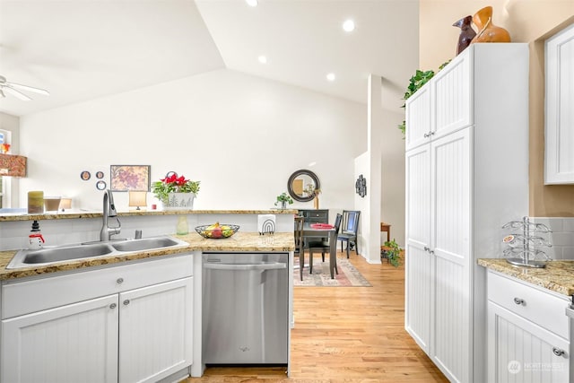 kitchen featuring white cabinetry, sink, stainless steel dishwasher, and light wood-type flooring