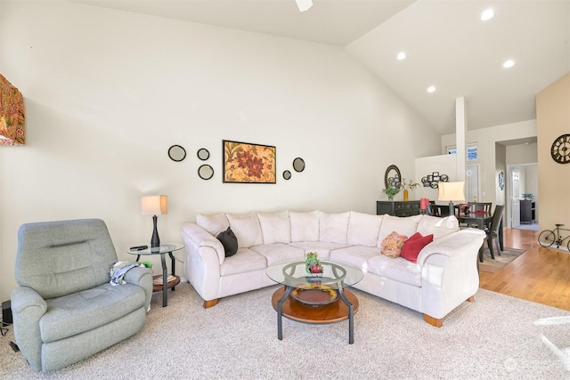 living room featuring vaulted ceiling and light wood-type flooring