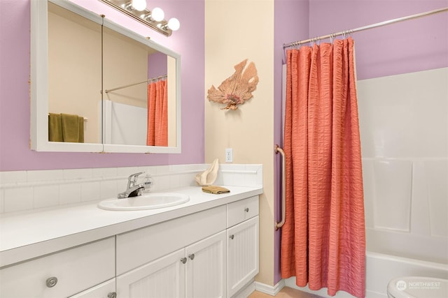 bathroom with shower / bath combination with curtain and vanity