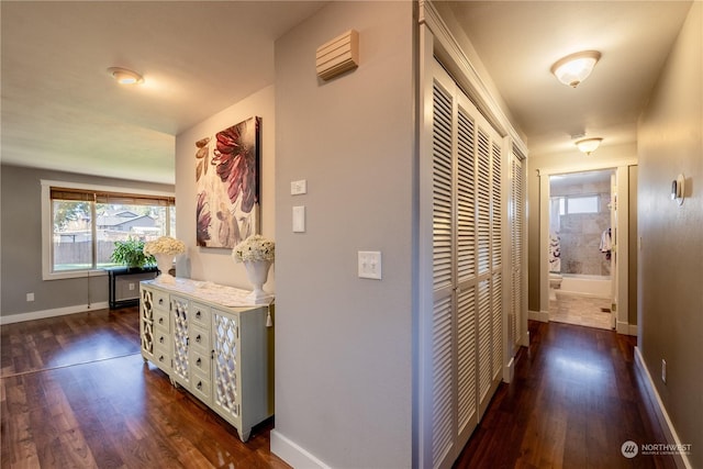 hall with dark wood finished floors and baseboards