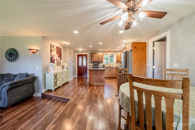 dining space featuring recessed lighting, baseboards, and wood finished floors