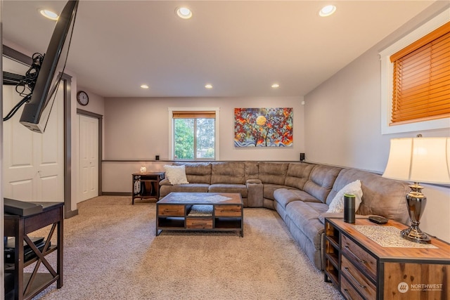 living room featuring recessed lighting, light carpet, and baseboards