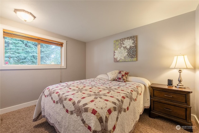 carpeted bedroom featuring baseboards