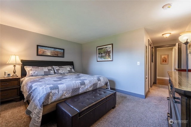 bedroom with carpet flooring and baseboards