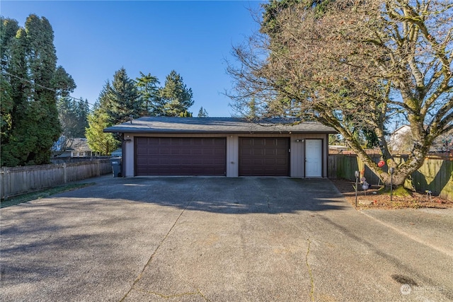 detached garage featuring fence