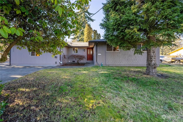 ranch-style house featuring driveway and a front yard