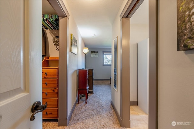 hallway with light carpet and baseboards