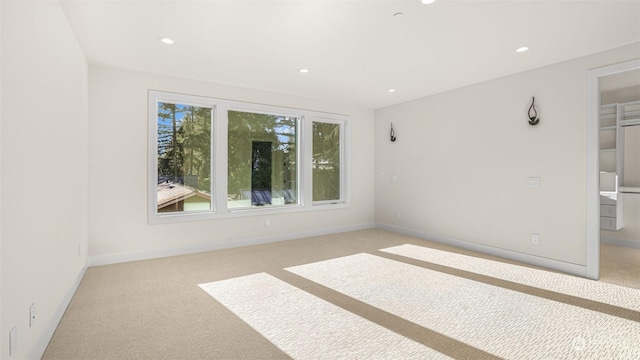 spare room featuring light colored carpet