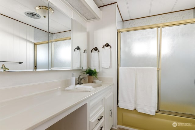 bathroom featuring vanity and shower / bath combination with glass door