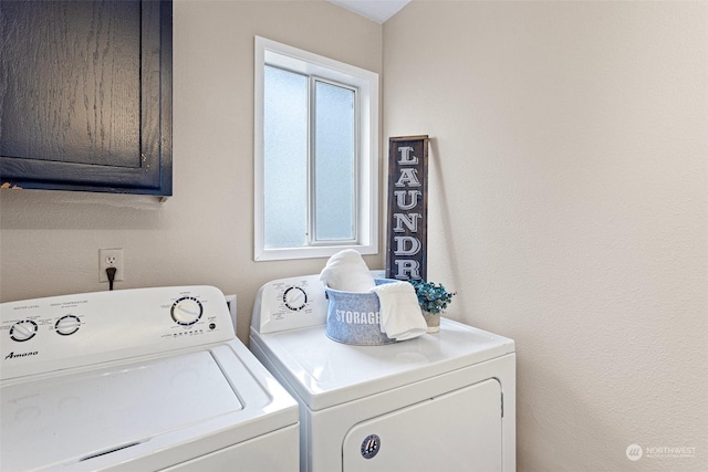 washroom featuring cabinets, a healthy amount of sunlight, and washing machine and clothes dryer