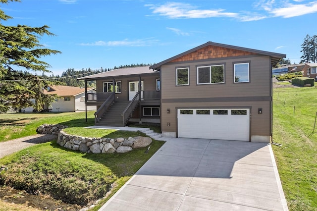 view of front of house with a garage and a front lawn