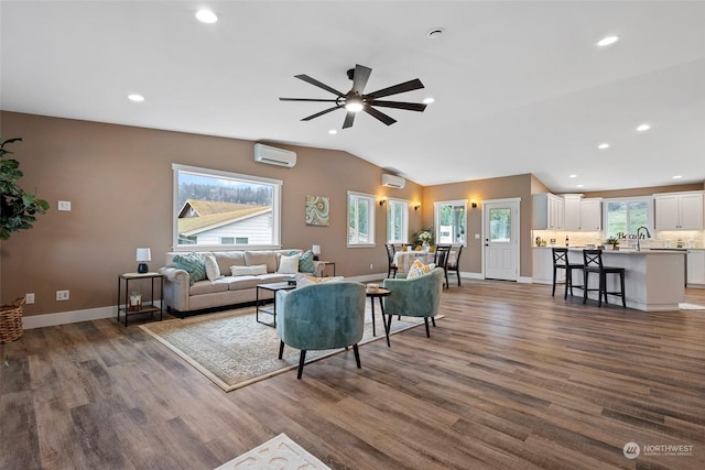 living room featuring dark hardwood / wood-style flooring, a wall mounted AC, and vaulted ceiling