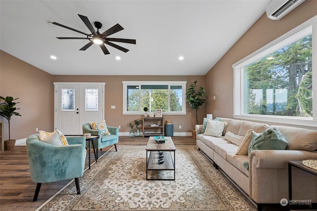 living room with a wall mounted air conditioner, vaulted ceiling, and hardwood / wood-style floors