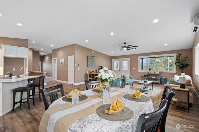 dining space with ceiling fan, lofted ceiling, dark hardwood / wood-style flooring, and sink