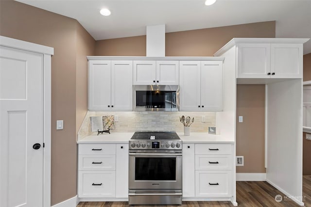 kitchen with stainless steel appliances, white cabinets, and backsplash