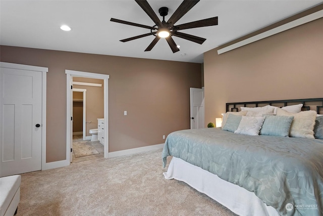 carpeted bedroom with ceiling fan and ensuite bath