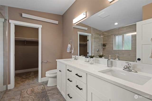 bathroom featuring vanity, toilet, and walk in shower