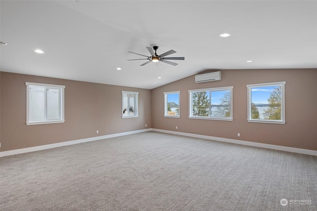 carpeted empty room featuring vaulted ceiling, ceiling fan, and a wall unit AC