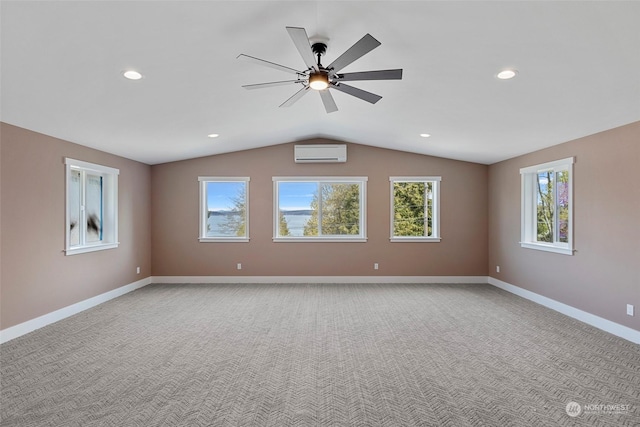 spare room featuring lofted ceiling, a wall mounted air conditioner, light colored carpet, and ceiling fan