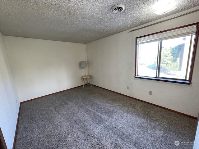 empty room featuring carpet floors and a textured ceiling