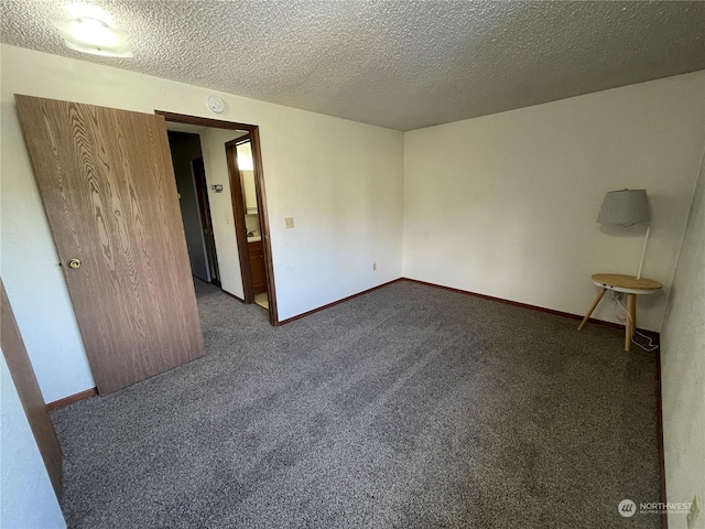 carpeted spare room featuring a textured ceiling